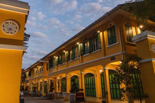 a building with a clock on the side of it at Bhirom at Baan Thongjaya in Ban Fon