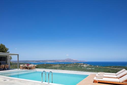 a swimming pool with a view of the ocean at Virtus in Mare in Tsivarás