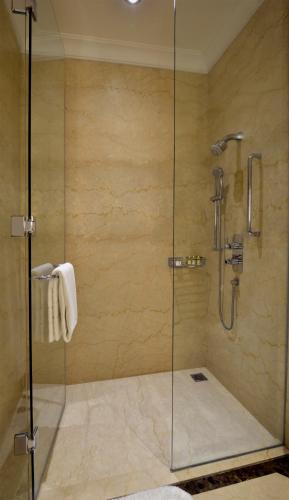 a shower with a glass door in a bathroom at Trident Gurgaon in Gurgaon