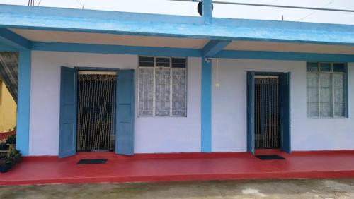 a small house with a blue roof at Iba Homestay in Cherrapunji