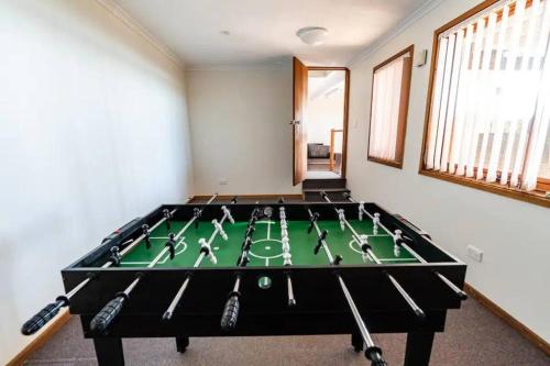 a room with a pool table in the middle of it at Serene 5 BDRM Villa with Pool in Toukley