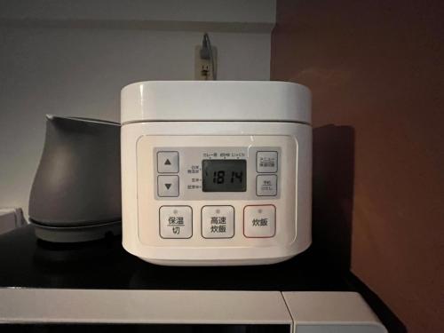 a microwave sitting on top of a counter at Chill out FUKUOKA in Fukuoka
