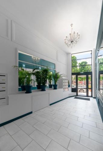 a hallway with potted plants in a building at Le Grand Wilson - Appartement design - Hyper centre in Vichy