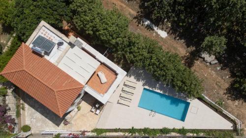 an overhead view of a house with a swimming pool at Aloe & Lotus Villas in Prinés