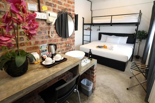 a hotel room with a bed and a table with a counter sidx sidx at Suite 18 Boutique Hotel in Kuala Terengganu