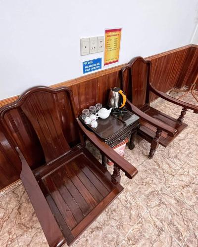 a wooden bench and a table with a tea kettle on it at Cực Bắc Hotel HG - by BAY LUXURY in Ha Giang