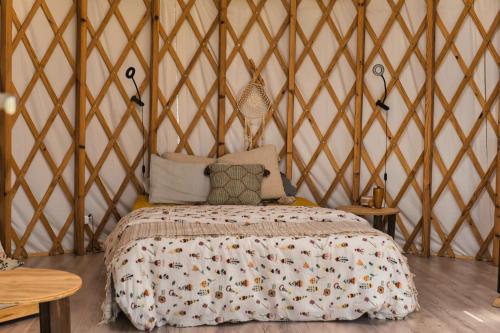 a bedroom with a bed in a yurt at La Muntanera - Eco Yurt - Pool, Nature retreat in Figuerola