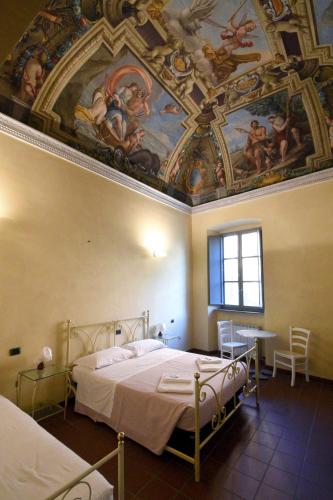 Katil atau katil-katil dalam bilik di Ostello Palazzo Pierantoni