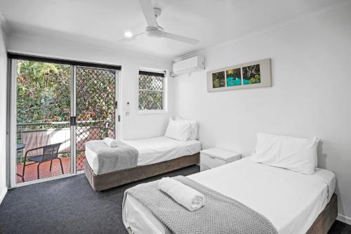 a bedroom with two beds and a balcony at Diamond Beach 35 in Gold Coast