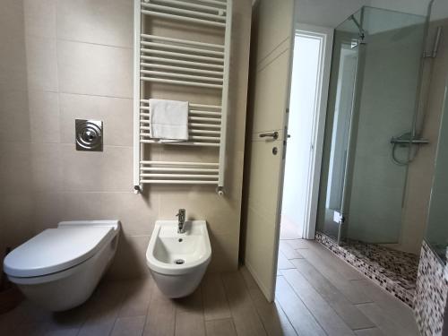 a bathroom with a toilet and a sink and a shower at IseoLakeRental - La Dolce Vista in Riva di Solto
