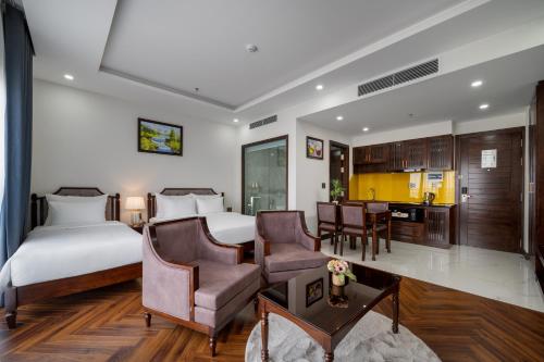 a hotel room with a bed and a kitchen at Florence Hotel in Da Nang