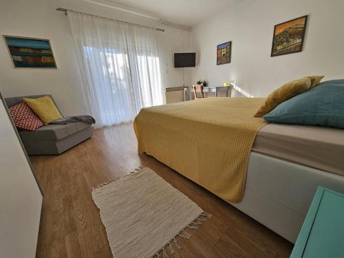 a bedroom with a large bed and a couch at Palme Apartments in Opatija