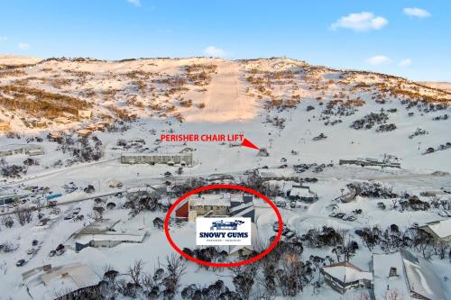 a building in the middle of a snow covered mountain at Snowy Gums Smiggins in Perisher Valley