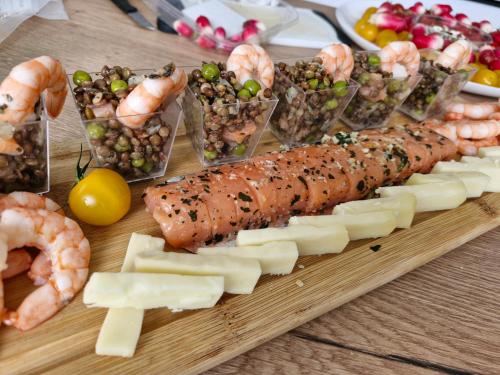 a board of food with shrimp and other foods on a table at Domaine Le Clos du Figuier Spa Grisolles in Verdun-sur-Garonne