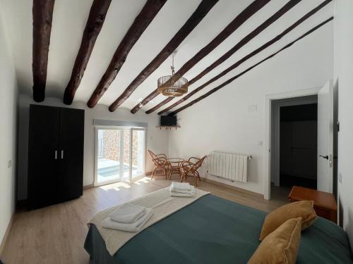 a bedroom with a bed and a table and chairs at Casa Azul in Vélez Blanco