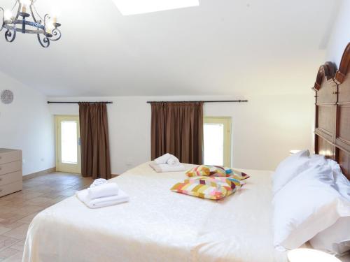 a bedroom with a large white bed with two pillows at La Piccola Bellagio in Bellagio