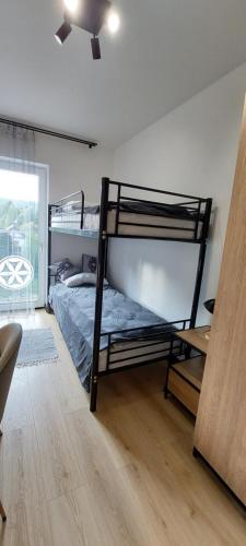 Katil atau katil-katil dalam bilik di Apartamenty Trzy Kopce Ski & Bike & Sauna