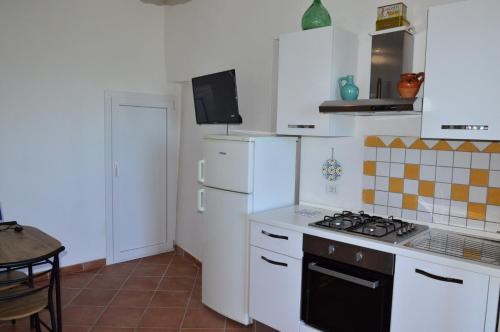 a kitchen with a stove and a white refrigerator at Virginia house in Montefiascone