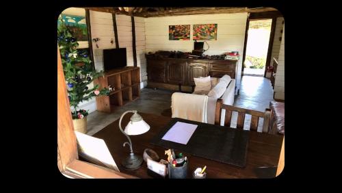 a living room with a table and a couch at Beach front Cottage in Mahambo
