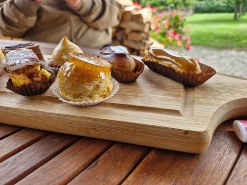 a wooden tray with muffins on a table at Domaine Le Clos du Figuier Spa Grisolles in Verdun-sur-Garonne