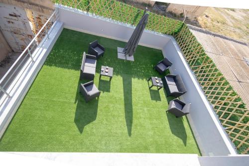 an overhead view of a patio with chairs and grass at Elysium B&B in Mazara del Vallo