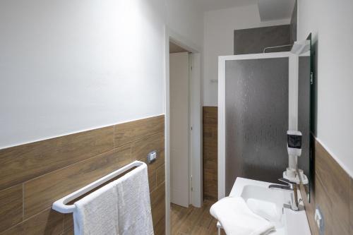 a bathroom with a white sink and a mirror at Elysium B&B in Mazara del Vallo