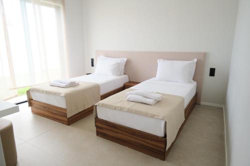 Postel nebo postele na pokoji v ubytování Ashta Suites / Zen Suite