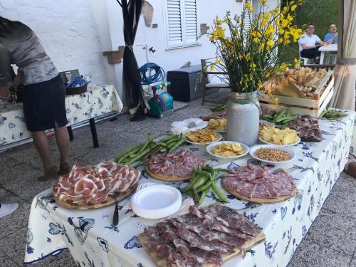 a table topped with different types of meats and vegetables at Ala di Maniero in Agriturismo Valdrago in Toscana, nel Verde Mugello sulle Colline di Firenze Autodromo Mugello Circuit in Borgo San Lorenzo