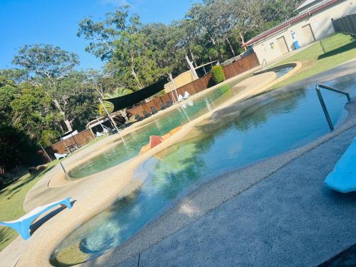 an empty swimming pool with a slide in the middle at Island Leisure Village in Bobs Farm