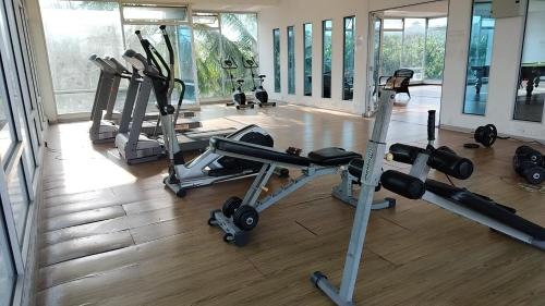 a gym with several tread machines in a room at Idea Homestay 3 in Chemor