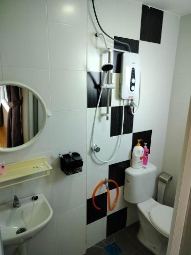 a bathroom with a shower and a toilet and a sink at Idea Homestay 3 in Chemor