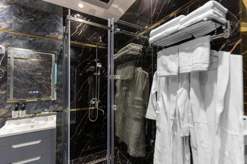 a bathroom with a shower and a sink and towels at HOTEL SULTAN PALACE in Samarkand