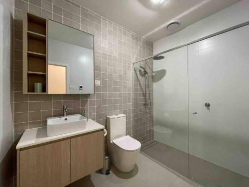 a bathroom with a toilet and a sink and a shower at Lovely place in Bruce centre (2-bedroom-townhouse) in Belconnen