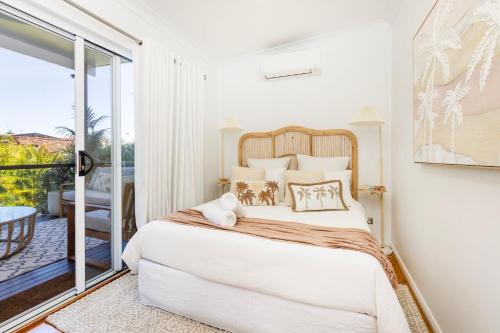 a bedroom with a bed and a balcony at 3 Pillars - Pet Friendly - 4 Mins Walk to Beach in Callala Beach