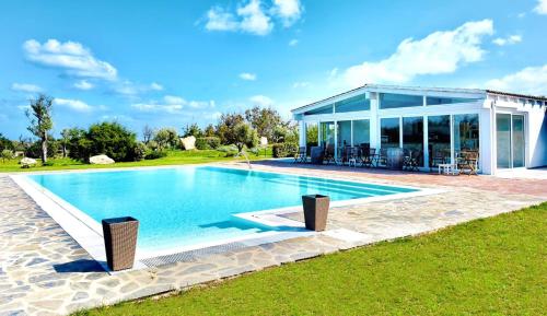 a swimming pool in front of a house at 309 Le Saline - Stintino in Stintino
