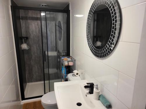 a bathroom with a shower and a sink and a mirror at Charming 2-Bed Apartment in Birmingham in Birmingham