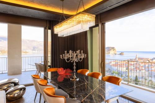 a dining room with a view of the ocean at Merit Starlit Hotel & Residences in Budva