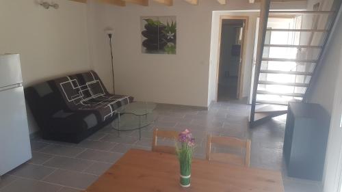 a living room with a couch and a table at L'Alizée in Josse