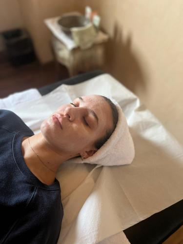 a woman laying on a bed with a towel on her head at Agriturismo Fattoria Lavacchio in Pontassieve