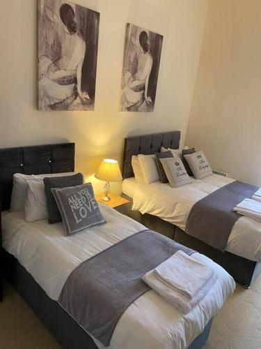 two beds in a room with at The Waterfront Suite in Southport
