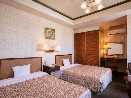 Katil atau katil-katil dalam bilik di Sunrise Kanko Hotel