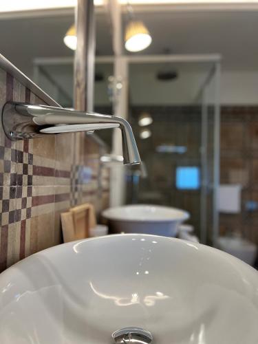 a bathroom sink with a faucet on top of it at San Gemini Palace in San Gemini