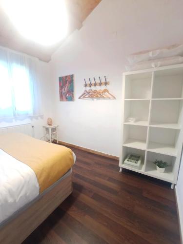 a bedroom with a bed and a book shelf at CAN VICENS in Caldes de Malavella