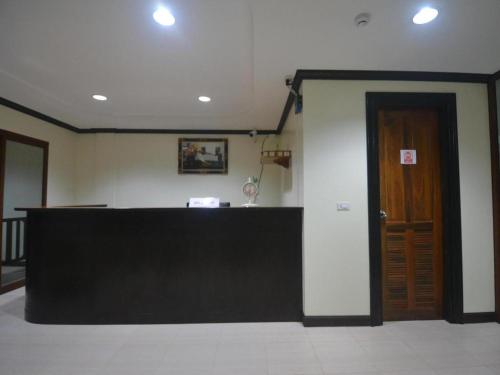 a reception desk in a room with a door at The Green Hotel in Ko Lipe