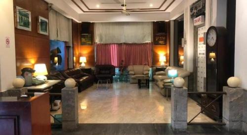 a living room with a couch and a table at S.C. Heritage Hotel in Hat Yai