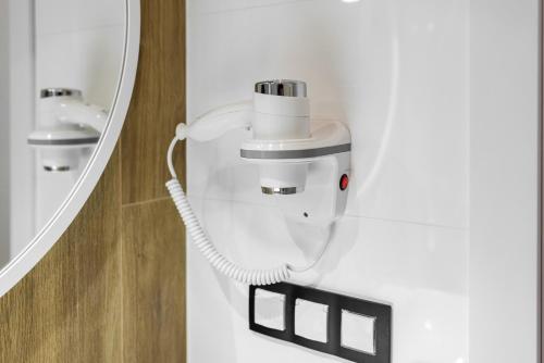 a bathroom with a sink and a mirror at Q18 ApartHotel in Bydgoszcz