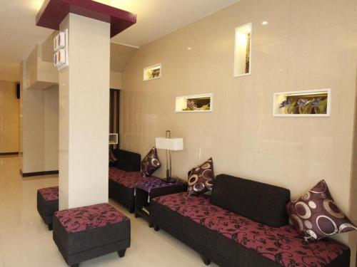 a living room with couches and a column at Cityinn Hotel in Zamboanga