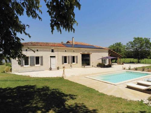 a house with a swimming pool in front of it at Gîte avec piscine au cœur de la campagne 