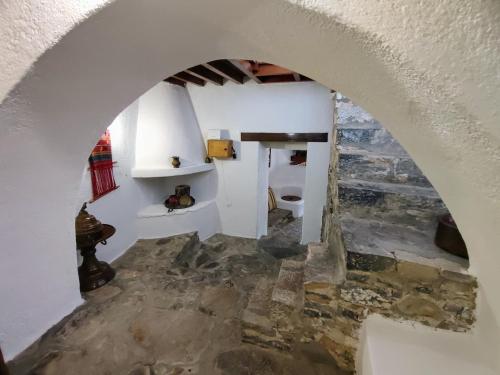 an arched hallway in a house with a stone floor at Elounda Traditional Homes of Crete in Elounda