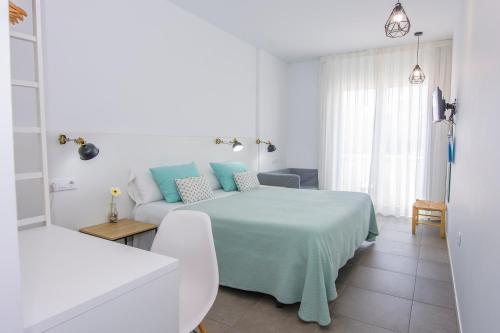 Ένα ή περισσότερα κρεβάτια σε δωμάτιο στο Hostal La Isla